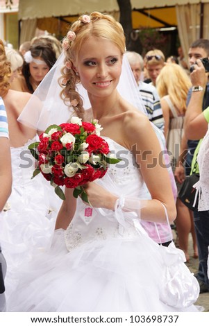 ODESSA, UKRAINE - MAY 27 : Annual event Bride Parade. Happy excited participants in fiancee`s gowns take part in celebration of marriage and romance Bride Parade on May 27, 2012 in Odessa, Ukraine