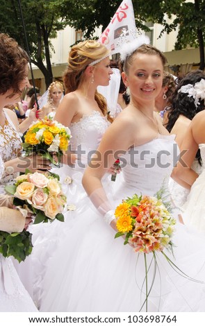 ODESSA, UKRAINE - MAY 27: Annual event Bride Parade. Happy excited participants in fiancee`s gowns take part in celebration of marriage and romance Bride Parade on May 27, 2012 in Odessa, Ukraine