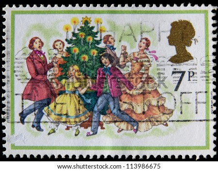 UNITED KINGDOM - CIRCA 1977: A post stamp printed in the Great Britain shows Carol Singers around a Christmas Tree, circa 1977