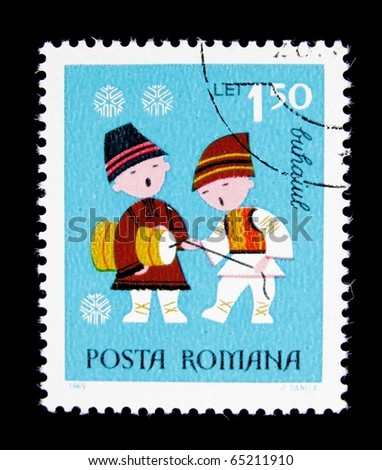 ROMANIA - CIRCA 1969 :A post stamp printed in Romania shows Romanian boys in national dress singing carol, circa 1969