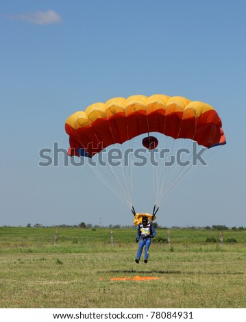 ODESSA,UKRAINE - MAY 27: Landing of the parachutist on Air Show devoted the 100th anniversary of Odesaviaremservice.  May 27, 2011 in Odessa, Ukraine