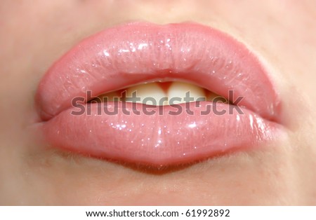 close up of a pink mouth with lipstick and lip gloss