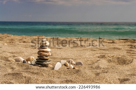 zen like high balanced stones pile on the sea beach