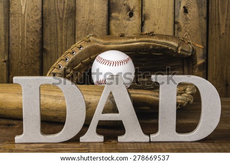 large letters spelling dad in front of baseball bat and baseball in glove
