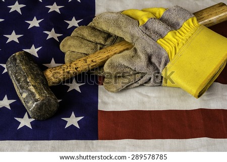 hammer and work gloves on american flag