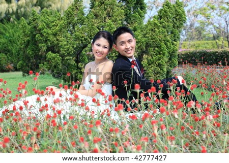 Image of a bride and groom who is sitting out in the sun in the beautiful garden.