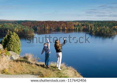 Girls throwing stones from hills edge
