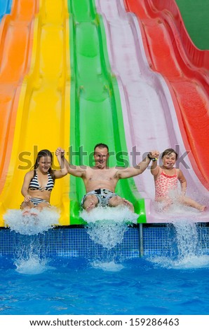 Happy family jump from the slide