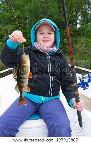 Happy boy with perch fish trophy