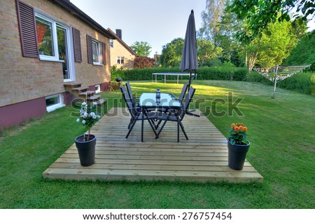 Modern villa backyard with garden furniture
