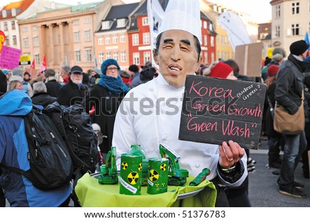COPENHAGEN - DECEMBER 12: Caricature of USA president Barack Obama carrying nuclear equipment on plate during environment protest, in state central market, December 12, 2009 in Copenhagen, Denmark.
