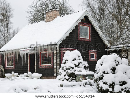 Winter cottage with long icicles