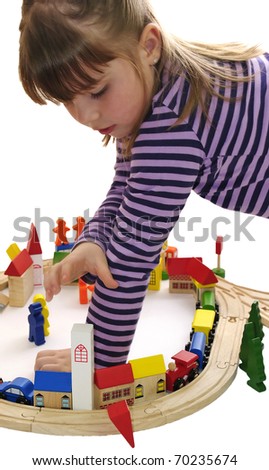 Five year old girl playing with wooden blocks