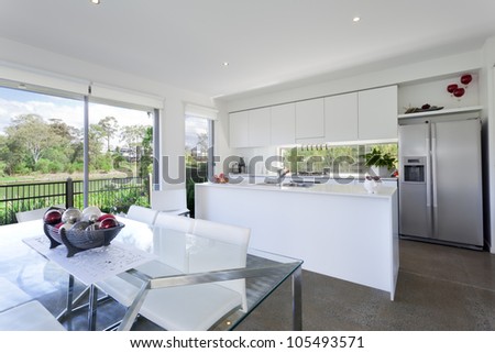 Modern kitchen and dining room with stainless steel appliances in Australian mansion