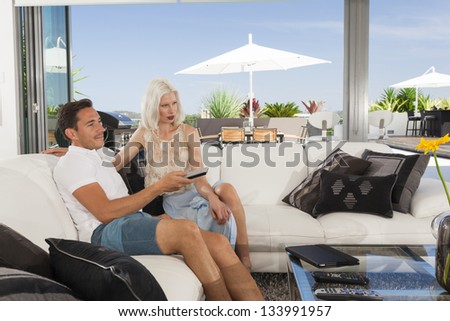 Young couple relaxing on couch in luxury living room