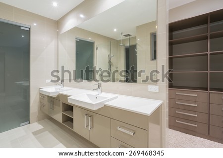 Spacious contemporary bathroom with walk in wardrobe