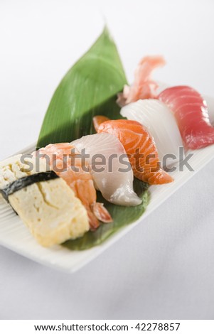 sushi plate with tofu, prawn ,king fish,salmon,octopus and tuna