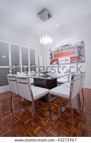Luxury home dining room interior with dark brown wooden flooring and white leather dining furniture