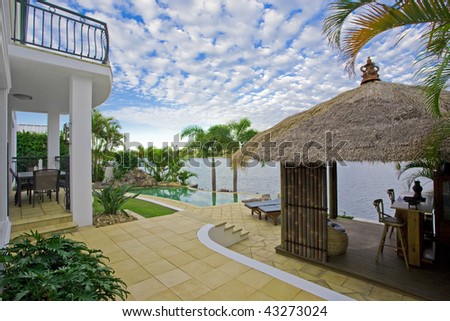luxury mansion outside deck with Bali hut, bar and pool