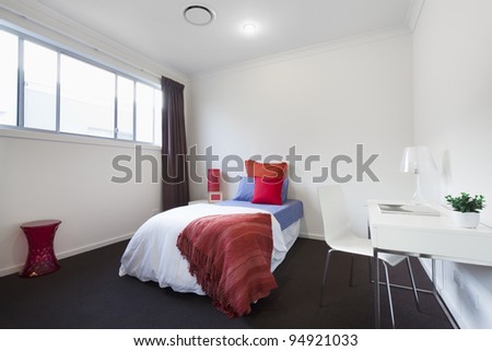 Modern bedroom with single bed, table and chair