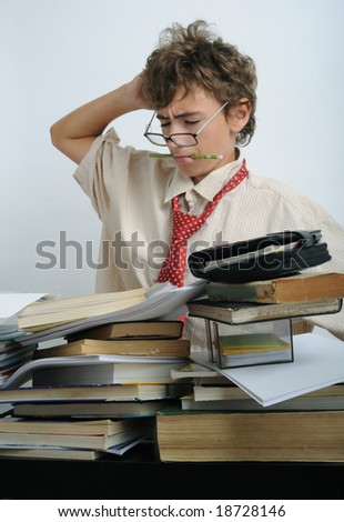 A boy behind a fully covered desk