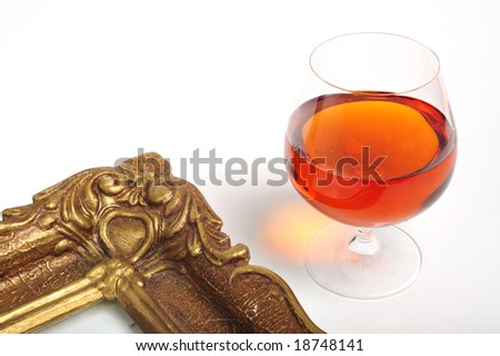 Cognac in brandy snifter and a picture frame