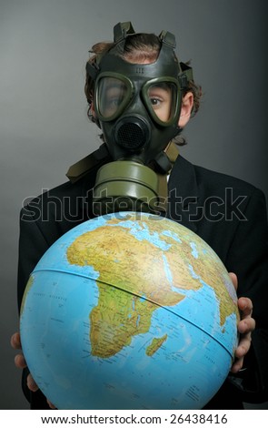 Businessman with gas mask on face holding earth globe