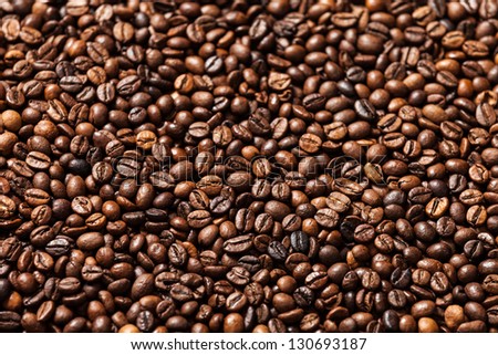 Brown roasted raw coffee bean heap background