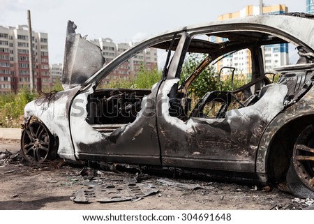 Road wreck accident or arson fire burnt wheel car vehicle junk