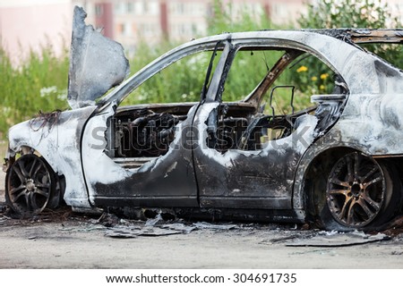 Road wreck accident or arson fire burnt wheel car vehicle junk