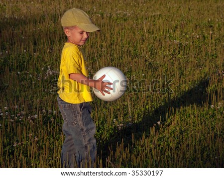 Little child and ball playing soccer sport for fun