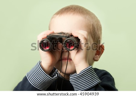 Little child boy looking binoculars lens isolated