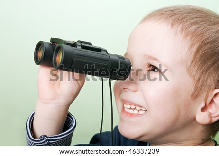 Little child boy looking binoculars lens isolated
