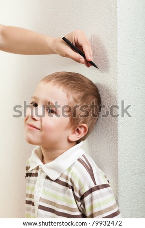 <b>Human hand</b> measure little child boy height growth - stock-photo-human-hand-measure-little-child-boy-height-growth-79932472