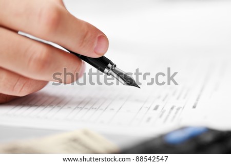 Working business man hand pen writing paper document at office workplace
