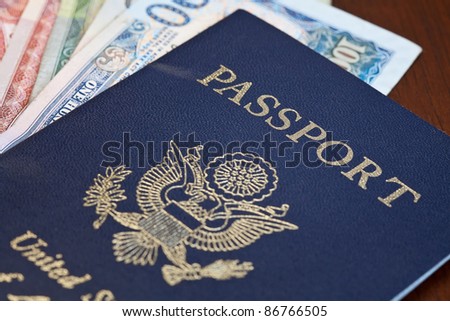 Macro shot of passport and foreign currency