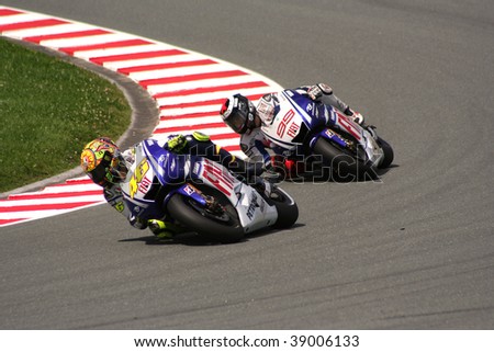 SACHSENRING, GERMANY - JULY 19, 2009: Teammates Valentino Rossi and Jorge Lorenzo fighting hard during 2009 Alice German Motorcycle Grand Prix at Sachsenring Circuit in Germany