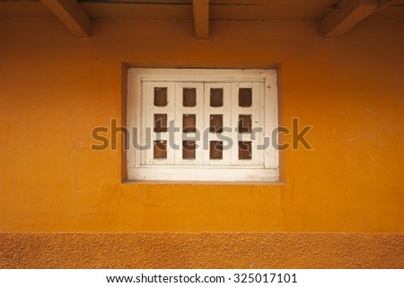White square window with orange wall - Mexico