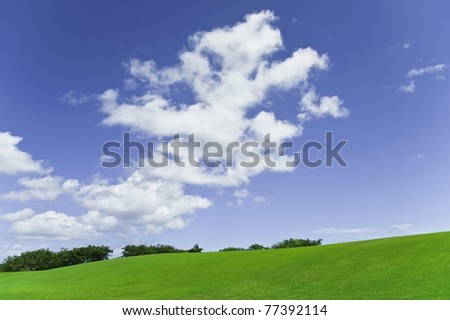 Golf course against deep blue sky with clouds and sand pools under white puffy clouds and the caribbean sun in tropical barbados in the western corner of the island
