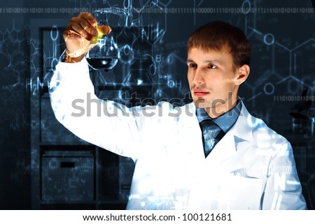 Young chemist in white uniform working in laboratory