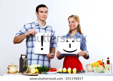 Happy husband and wife cooking together at home