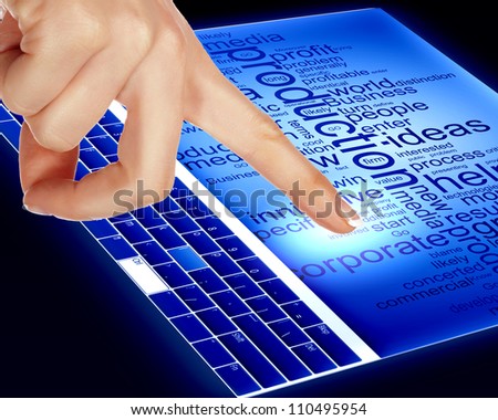Finger touching a blue computer screen with word on it