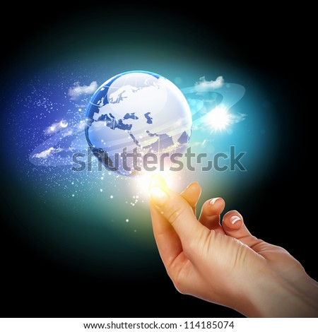 Human hand holding our planet earth glowing