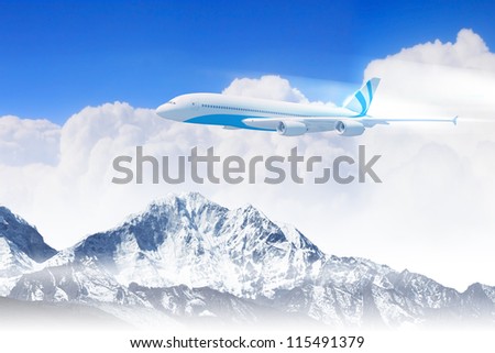 White passenger plane flying in the blue sky above the mountains with snow tops