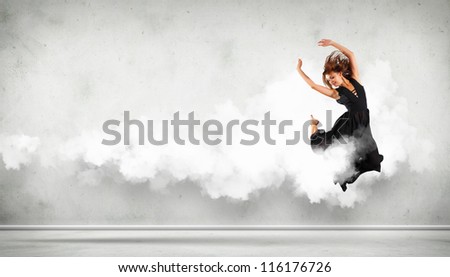 Portrait of a dancing young woman with white cloudy smoke