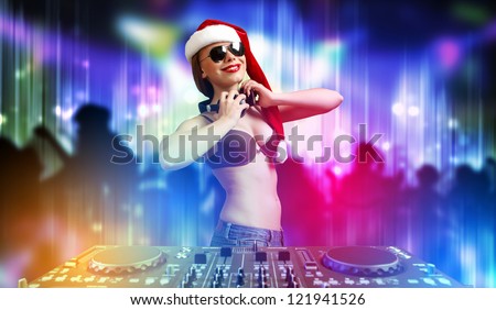 Young brunette woman in christmas wear with earphones