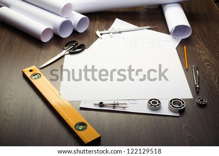 Tools and papers with sketches on the table Tools and papers with sketches on the table