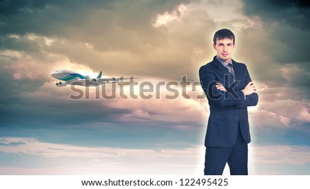 Businesman and plane on the background against cloudy sky