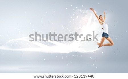 Modern style female dancer jumping and posing with lighting