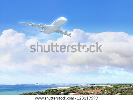 White passenger plane flying in the day blue sky above a city